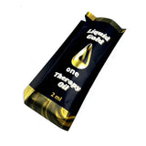 A small 2ml packet of Liquid Gold One Therapy Oil (angled shot)